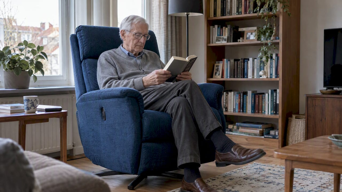 Oudere man leest rechtop in een blauwe relaxfauteuil
